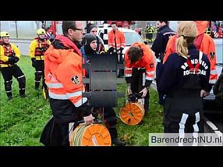 Black and Red Rubber Drysuit Viking Divers prepare to help Car Rescue
