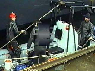 Black Rubber Drysuit Divers in Action on Ship