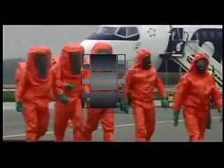 Orange Hazmat Suits at Airport Hazmat Incident
