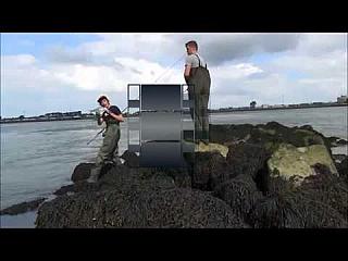 Two Young Lads in Green Chest Waders Fishing