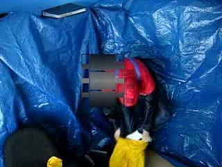 dressing up in yellow rainsuit with gasmask