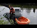 Guy in Inflated Orange and Black Drysuit in Car Rescue
