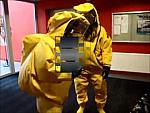 Two Firemen in Yellow Hazmat Suits in Fire Station