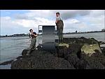 Two Young Lads in Green Chest Waders Fishing
